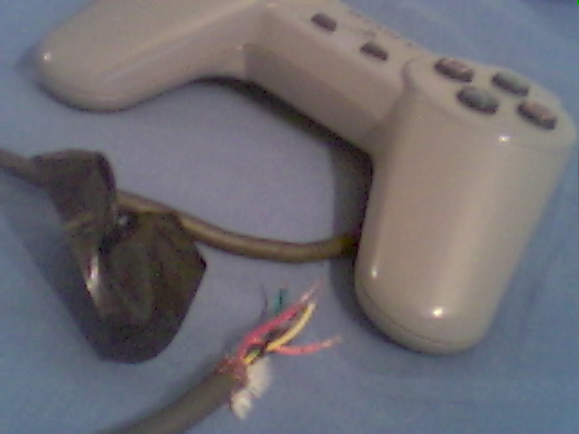 A hacked Playstation game controller used in the custom Dance Dance Revolution dance pad.